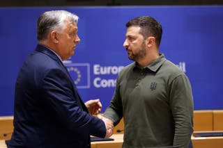 Hungary PM Viktor Orban speaks with Ukraine's president Volodymyr Zelensky during a round table meeting at an EU summit in Brussels in 2024